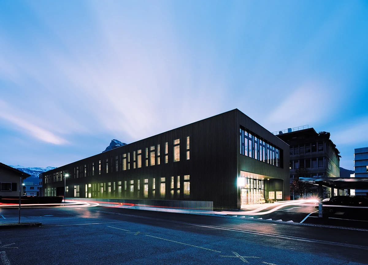 Dark-clad production building at dusk