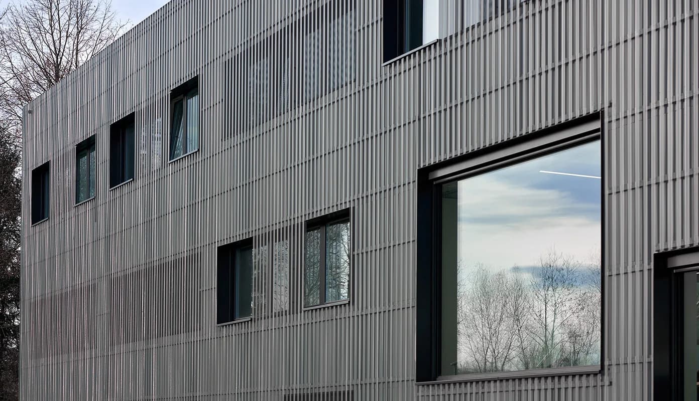 Grey metal façade with windows and glazing