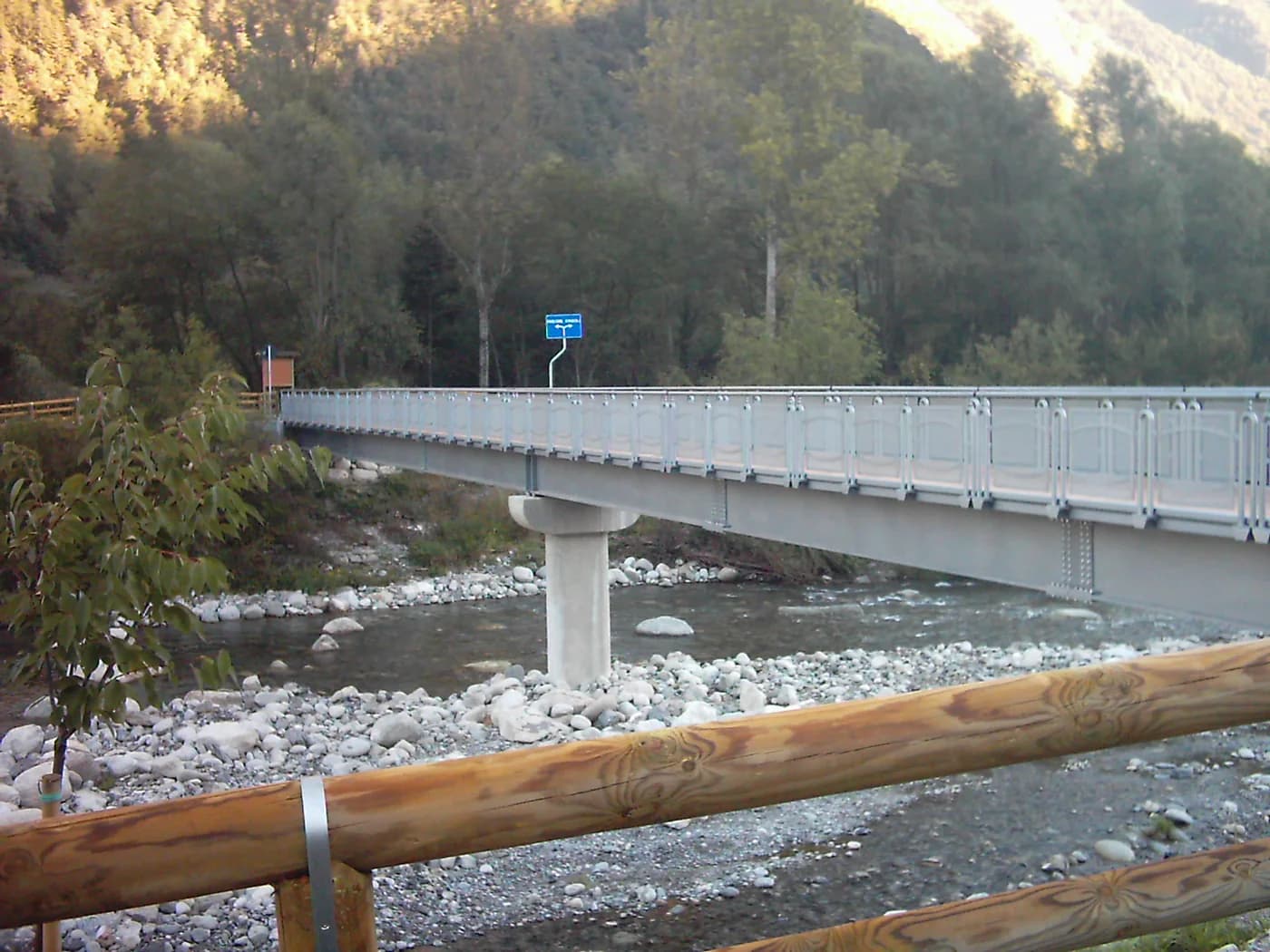 Steel pedestrian and cycle bridge over a wooded stream